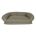 Green pet bed with white piping on a white background