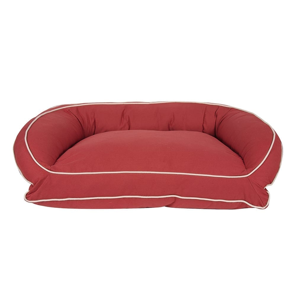 Red pet bed with white trim on a white background