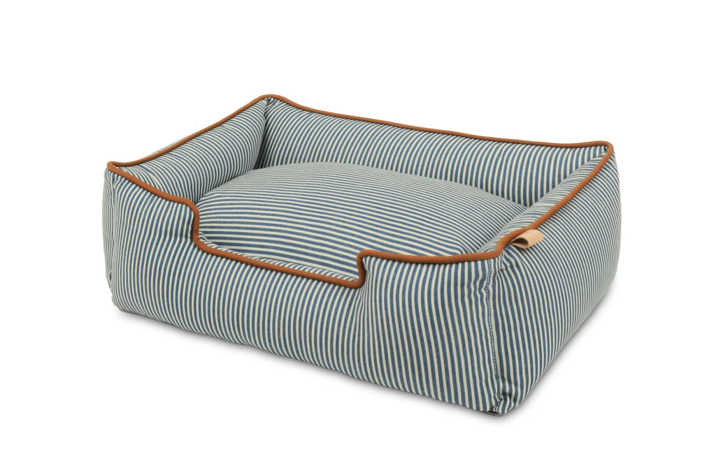 Pet bed with blue and white striped pattern and brown trim on a white background