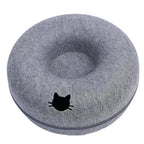 Gray donut-shaped pet bed with a black cat silhouette on a white background