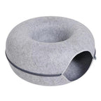 Gray donut-shaped pet bed on a white background